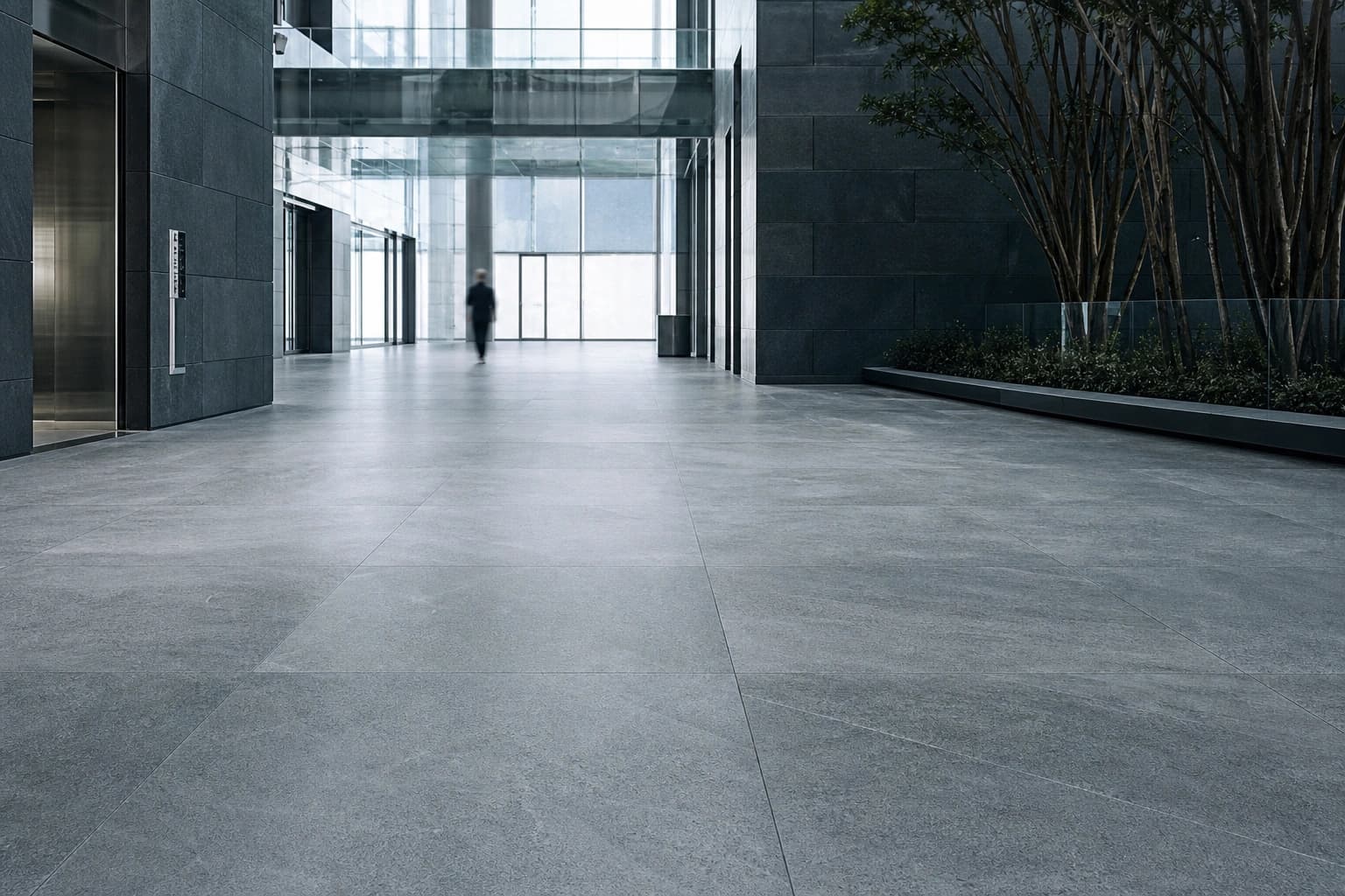 Matte full-body vitrified tile floor across a modern commercial concourse.
